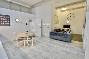 a living room with a table and a couch at City Loft Apartment in Coventry