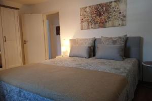 a bedroom with a large bed with two pillows at Wohnung direkt am Tegernsee mit XL-Terrasse in Gmund am Tegernsee