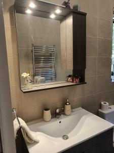 a bathroom with a sink and a mirror at Modern stylish flat near Valletta and Sliema! in Msida