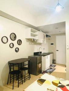 a kitchen with a table and chairs in a room at 2313 Sun Vida Tower in Cebu City