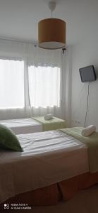 Łóżko lub łóżka w pokoju w obiekcie Apartamento Hacienda San Manuel