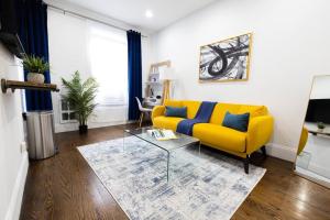 a living room with a yellow couch and a table at 69-2D Stylish Lower East Side 1BR Apt BRAND NEW in New York