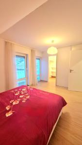 a large red bed in a room with a window at Modern & cozy house with 3 bed rooms and garden in Prievoz