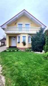 a house with a green lawn in front of it at Modern & cozy house with 3 bed rooms and garden in Prievoz