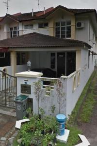 a white house with a fence and a yard at Cozy house with free parking near Utm, Legoland in Skudai