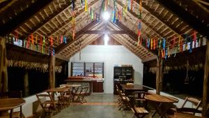 a dining room with tables and chairs and flags at Casa Saimiri in Alter do Chao