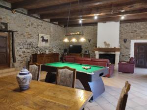 a living room with a pool table and a couch at LES 2 CHENES in Les Riffes