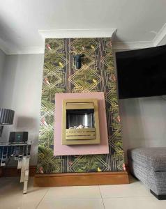 a wall with a fireplace in a living room at Flosh Cottage Lake District in Cleator