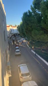 a street with cars parked on the side of a building at La casa del parque in Arcos de la Frontera +6 photos