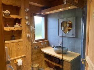 a bathroom with a stone sink and a window at Chalet d' Annelise in Gérardmer