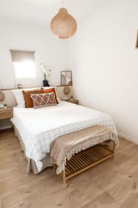 1 dormitorio con 1 cama blanca grande y suelo de madera en Terracotta by les Appartements Mistretta, en Sainte-Maxime