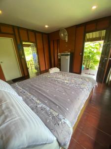 a bedroom with a large bed in a room at Mookdaman Bungalow in Ko Yao Noi