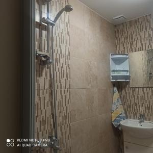 a shower in a bathroom with a toilet and a sink at СТОНЕЛ in Veliko Tŭrnovo