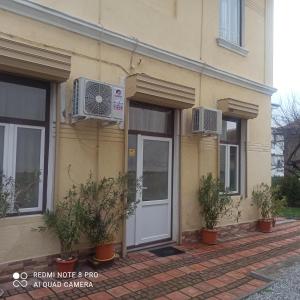 a building with a door and plants in front of it at СТОНЕЛ in Veliko Tŭrnovo