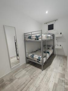 a room with two bunk beds and a mirror at Apartamento Vista Nevada in Sierra Nevada
