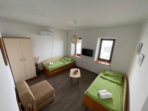 a small room with two beds and a couch at Savin Apartment in Ohrid