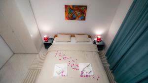a bedroom with a bed with pink confetti on it at 1st floorC in Pula