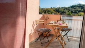 a table and two chairs on a balcony at 1st floorC in Pula