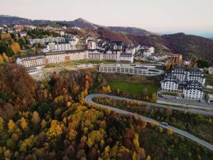 an aerial view of a city with buildings and a road at Kopaonik apartmani NR in Kopaonik