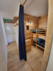 a small room with two bunk beds in it at Résidence le WAALA , face aux pistes in Les Deux Alpes
