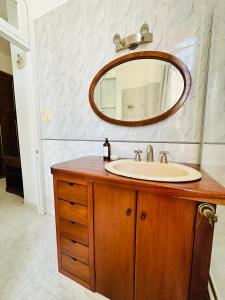 a bathroom with a sink and a mirror at V.60 in Nueve de Julio