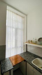 a kitchen with a sink and a window at V.60 in Nueve de Julio +17 photos
