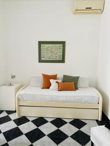 a bed in a room with a checkered floor at V.60 in Nueve de Julio