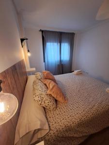 Un dormitorio pequeño con una cama con ventana. en Apartamento la moraña, en Arévalo