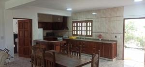 a kitchen with wooden cabinets and a table with chairs at La Viajera in San Lorenzo