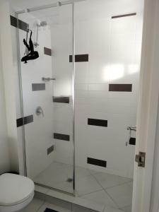a bathroom with a glass shower with a toilet at 3 bedroom 2 bath apartment in Cairns Queensland in Cairns