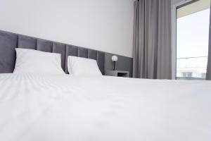 Posteľ alebo postele v izbe v ubytovaní Oli&Joly Baltic Marina