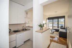 a kitchen and a living room in a house at APARTMAN DERETIC in Trebinje