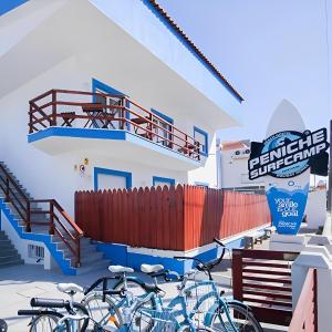 un gruppo di biciclette parcheggiate di fronte a un edificio di Peniche Surfcamp Hostel a Baleal