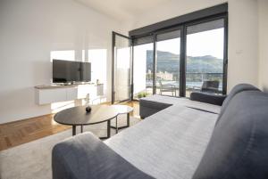 a living room with a couch and a table at APARTMAN DERETIC in Trebinje