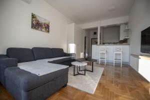 a living room with a couch and a table at APARTMAN DERETIC in Trebinje +8 photos