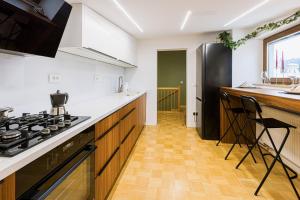 a kitchen with white counters and a black refrigerator at Apartments Šolar in Bled