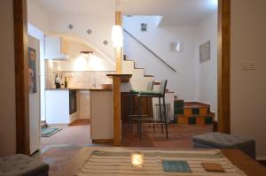 a living room with a kitchen and a stairway at Carmen de las Campanas in Granada