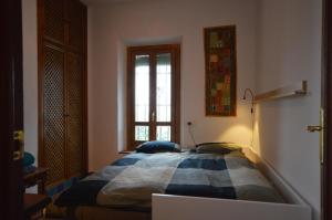 a bedroom with a bed in a room with a window at Carmen de las Campanas in Granada