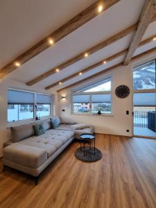 a living room with a couch and a table at Alpen Aparts Alteck in Rauris