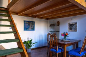 a room with a table and chairs and a staircase at Casa Antica Pizzofalcone in Naples