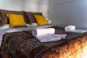 a bed with towels and pillows on top of it at Casa Antica Pizzofalcone in Naples