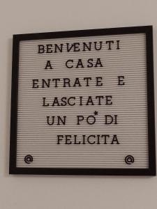 a sign on a wall with the words benoit a caesar encrade at Casa Lory in Colico