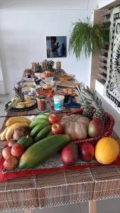 a table filled with lots of fruits and vegetables at Pousada Recanto Ha Mar in Maceió