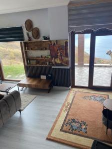 a living room with a couch and a view of the ocean at Shark SeaView Villa in Şarköy