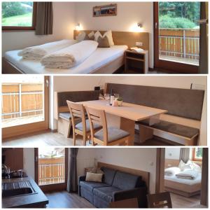a hotel room with a bed and a table at Pramstaller Apartments in San Lorenzo di Sebato