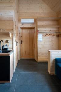 a cabin with a kitchen and a sink and a door at Poncyljuszówka in Szczyrk