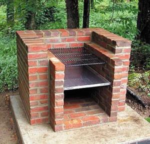 a brick oven with a grill inside of it at Teratak An Nur: A village on top of the hill in Kuala Pilah
