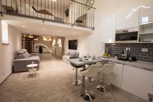 a kitchen and living room with a table and chairs at C'era una volta in Assisi