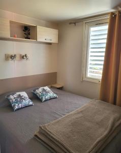 a bedroom with a bed with two pillows on it at Piana in Lumio