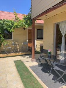 un patio con mesa y sillas junto a una casa en Hostal Playa Peñuelas, en Coquimbo